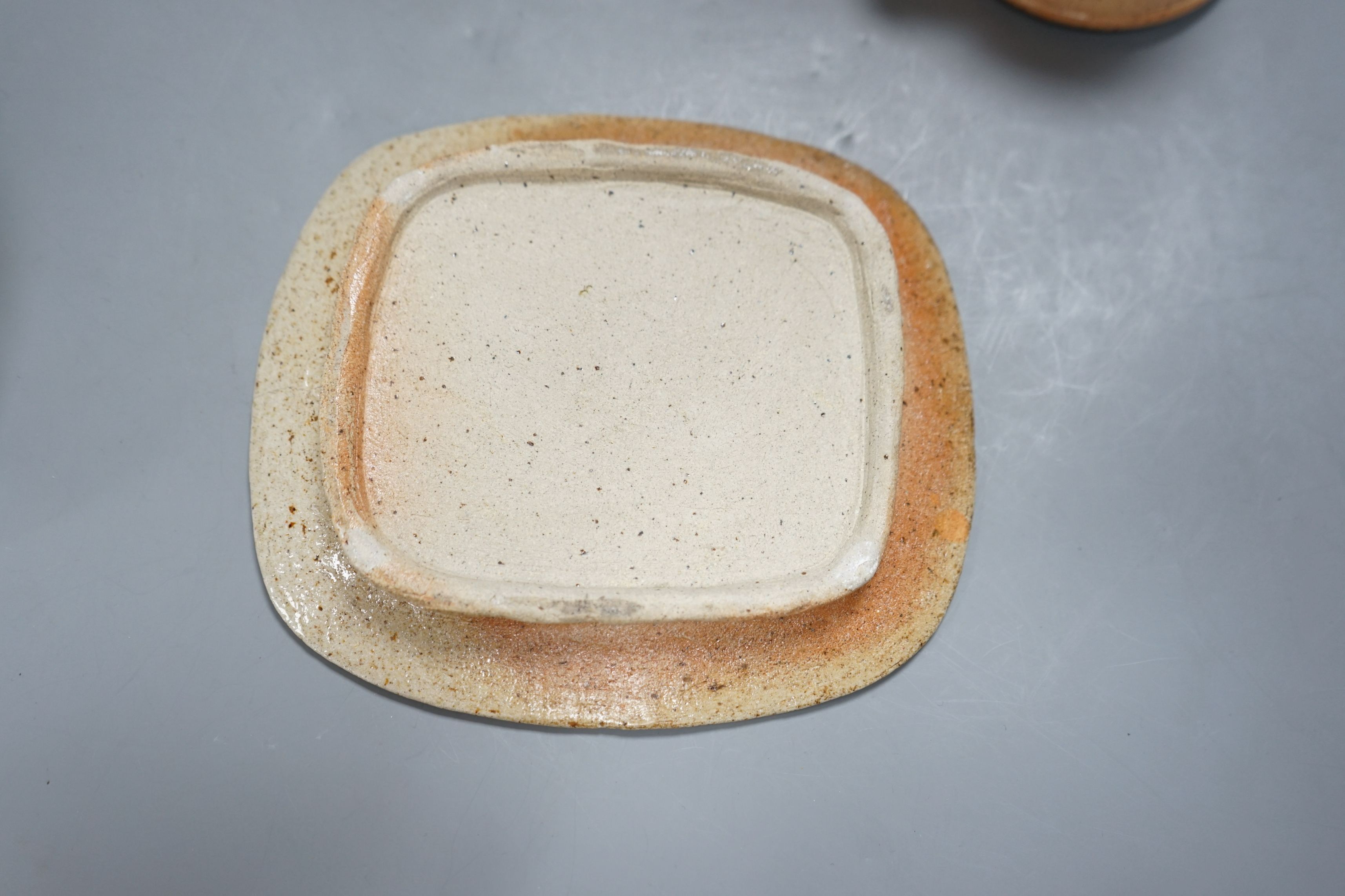 Sarah Walton (b.1945), a salt glazed stoneware flower brick, together with a salt glazed butter dish and cover, a similar mug, and a ‘Field’ horizontally carved linear slab, 22cm wide, all with impressed marks, (4)